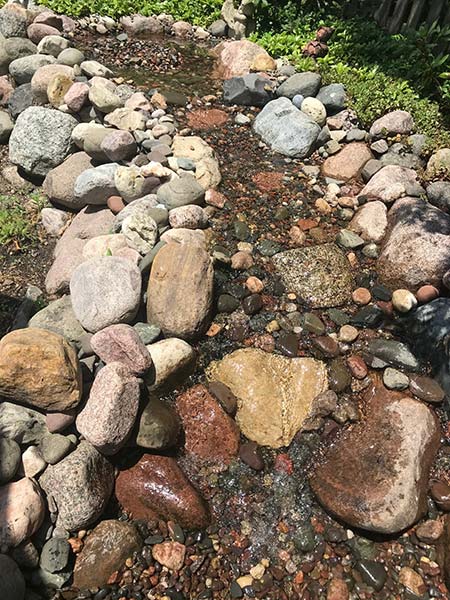 gravel and boulders enclosing a stream