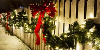 fence with boughs and red ribbon